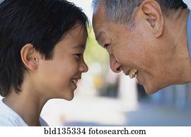 Senior man and grandson smiling outdoors Senior man and grandson smiling outdoors