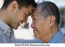 Senior man and son smiling outdoors Senior man and son smiling outdoors