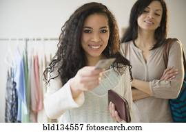 Teenage girl paying with credit card in store