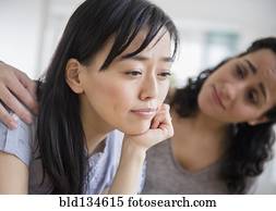 Woman comforting sad friend