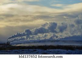 Distant power plant in arctic landscape