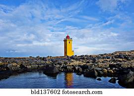 Lighthouse overlooking rocky landscape