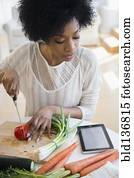 mulher americana africana, usando, tabuleta, computador, cozinhar