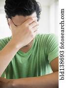 Frustrated mixed race man covering his face