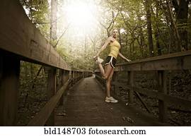 Caucasian woman stretching before exercise