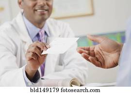 Doctor handing prescription to patient in doctor's office