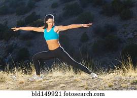 Hispanic woman stretching before exercise