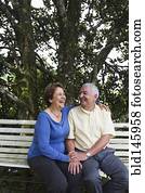 Senior Hispanic couple sitting on park bench Senior Hispanic couple sitting on park bench