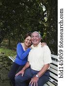 Senior Hispanic couple sitting on park bench Senior Hispanic couple sitting on park bench