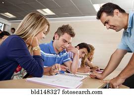 Teacher helping Hispanic college students