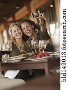 Women taking self-portrait in restaurant