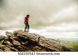Caucasian woman climbing rock formation