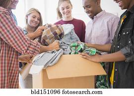 Teenagers donating clothes to charity