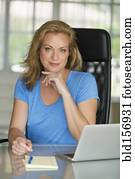 Caucasian businesswoman smiling at office desk