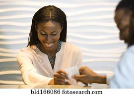 African American concierge checking guest into hotel