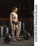 Caucasian athlete lifting weights in gym