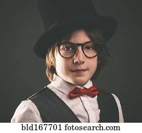 Close up of serious boy wearing top hat