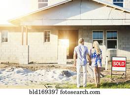 Caucasian couple admiring new home