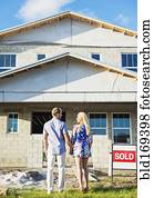 Caucasian couple admiring new home