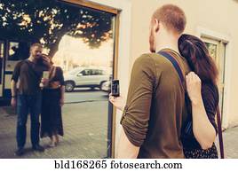 Caucasian couple taking self portrait in mirror
