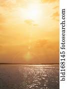 Sunset over rippling ocean water