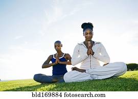 Women meditating in park
