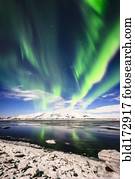 Northern lights reflecting in still remote river