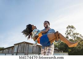 African American man carrying girlfriend