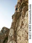 Climbers cheering on rock formation