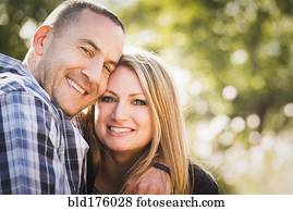 Smiling couple hugging outdoors Smiling couple hugging outdoors