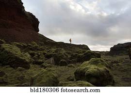 Caucasian hiker walking on rock formation