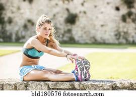 Caucasian woman stretching outdoors