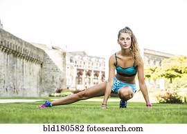 Caucasian woman stretching outdoors