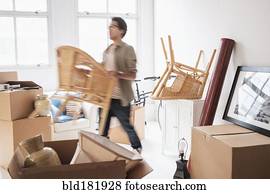 Mixed race man unpacking in new home