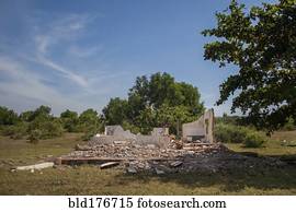Rubble of demolished building in rural field