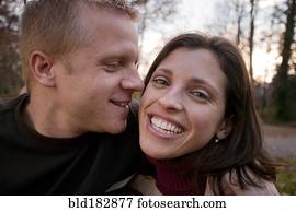 Smiling couple hugging outdoors Smiling couple hugging outdoors