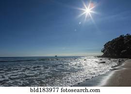 Sun over horizon at remote beach