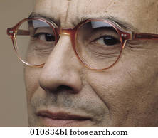 Mature man with horn-rimmed glasses looking into the camera Mature man with horn-rimmed glasses looking into the camera