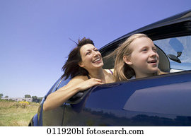happy mother and daughter sitting in car together happy mother and daughter sitting in car together