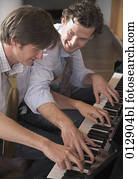 two good friends playing four handed piano two good friends playing four handed piano