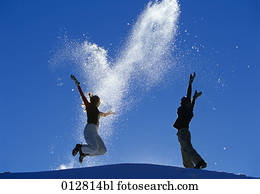 young couple jumping for joy on mountain young couple jumping for joy on mountain