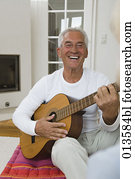 portrait of mature man playing guitar portrait of mature man playing guitar
