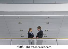 two executives having conversation in office building two executives having conversation in office building