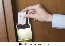 detail of young businesswoman opening door to hotel room with key card detail of young businesswoman opening door to hotel room with key card