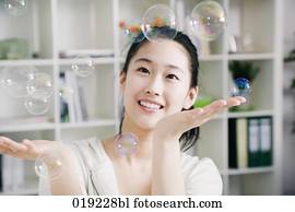 portrait of young japanese girl playing with soap bubbles portrait of young japanese girl playing with soap bubbles