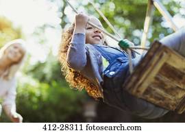 Carefree girl swinging in park