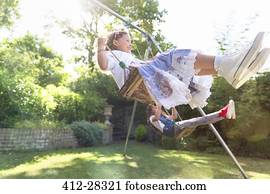 Carefree girls swinging in backyard