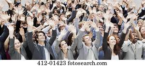 Crowd of business people cheering with arms raised