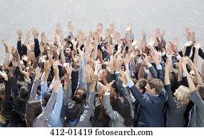 Crowd of business people cheering with arms raised