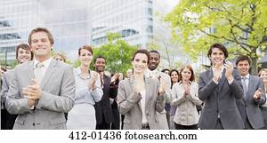 Portrait of clapping business people in crowd